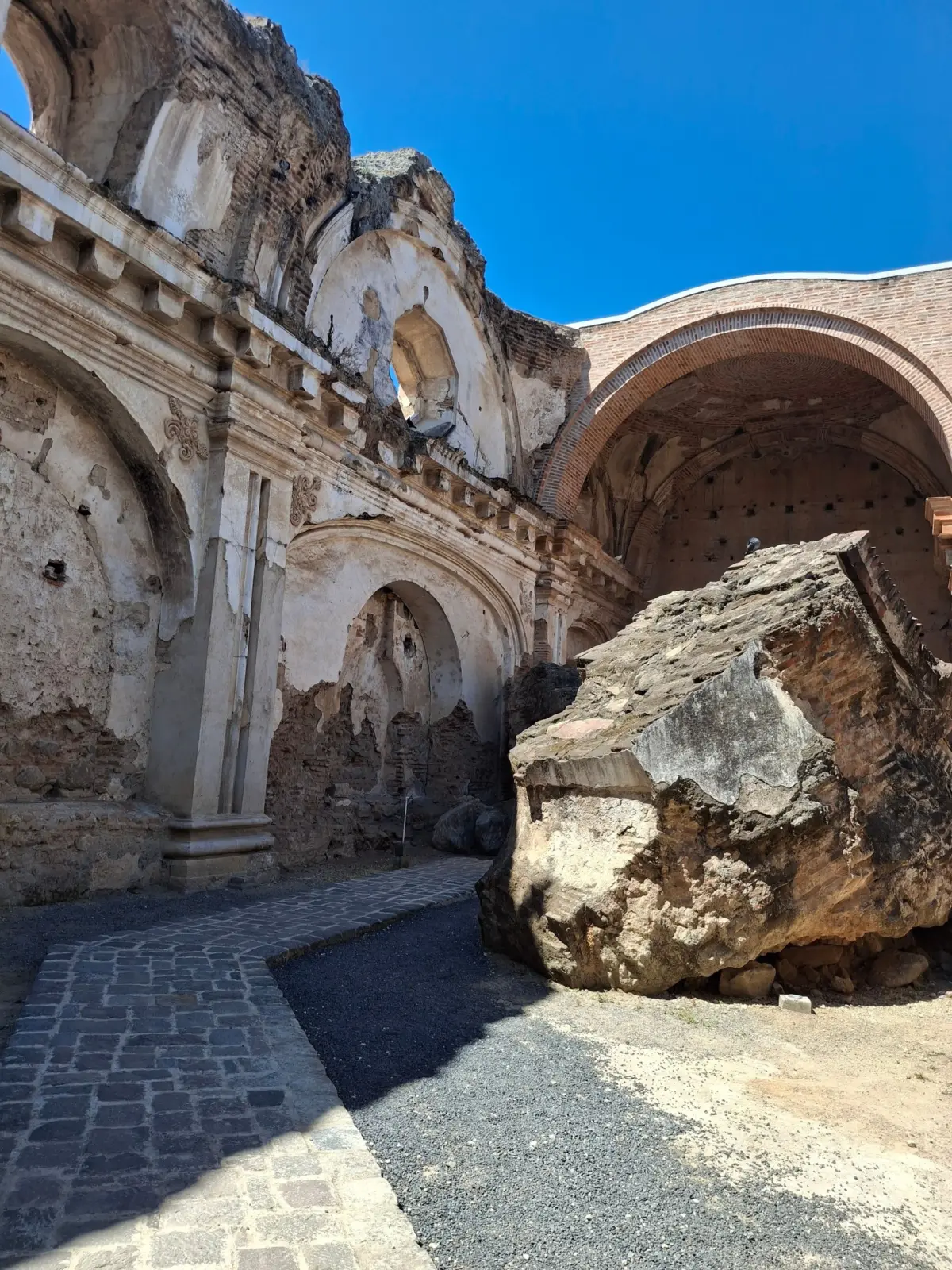 Ruins of a colonial church in Antigua Guatemala with arches and fallen masonry
