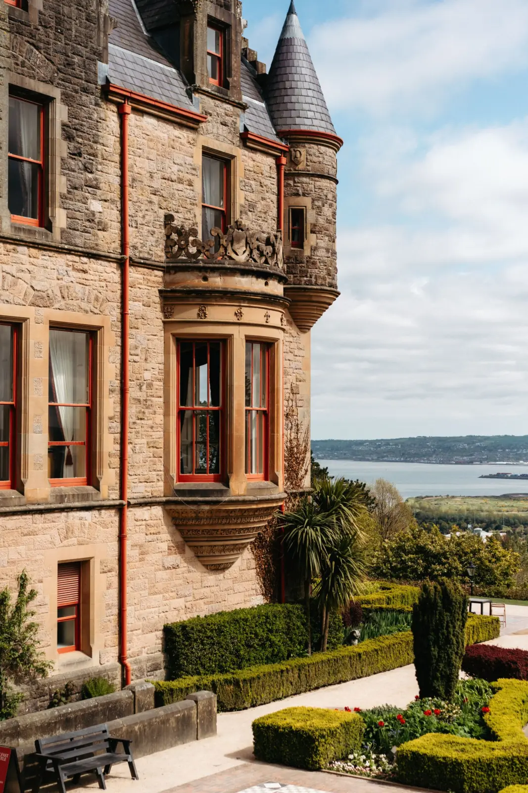 Belfast Castle façade and formal gardens overlooking the water in Belfast