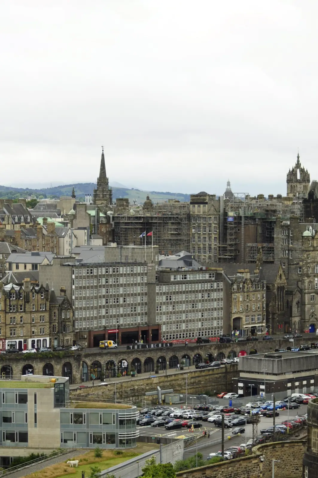 Edinburgh city centre skyline above railway arches and historic stone buildings