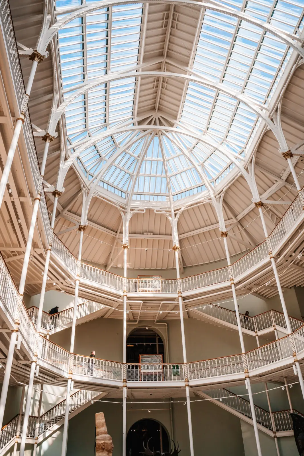 White iron galleries and glass-vaulted atrium inside the National Museum of Scotland in Edinburgh