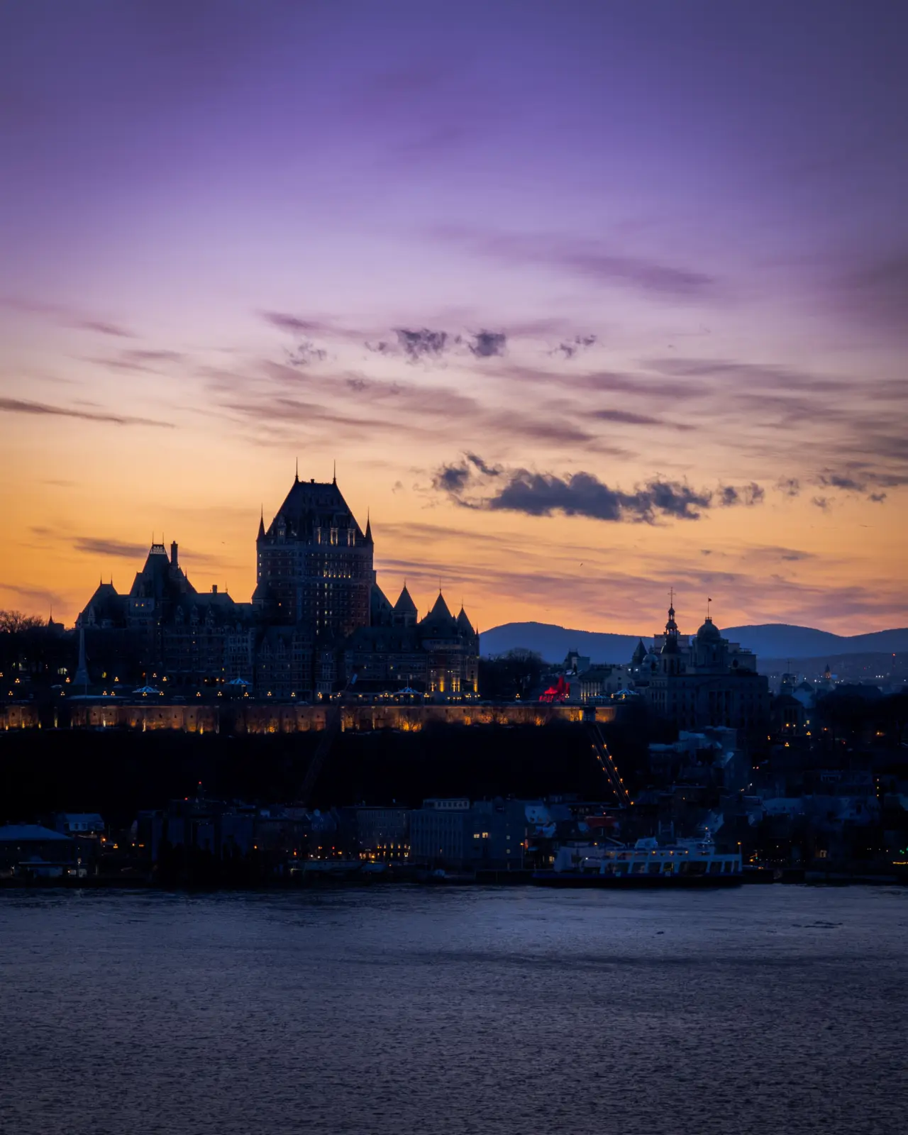 Château Frontenac and the Quebec City skyline across the river at dusk