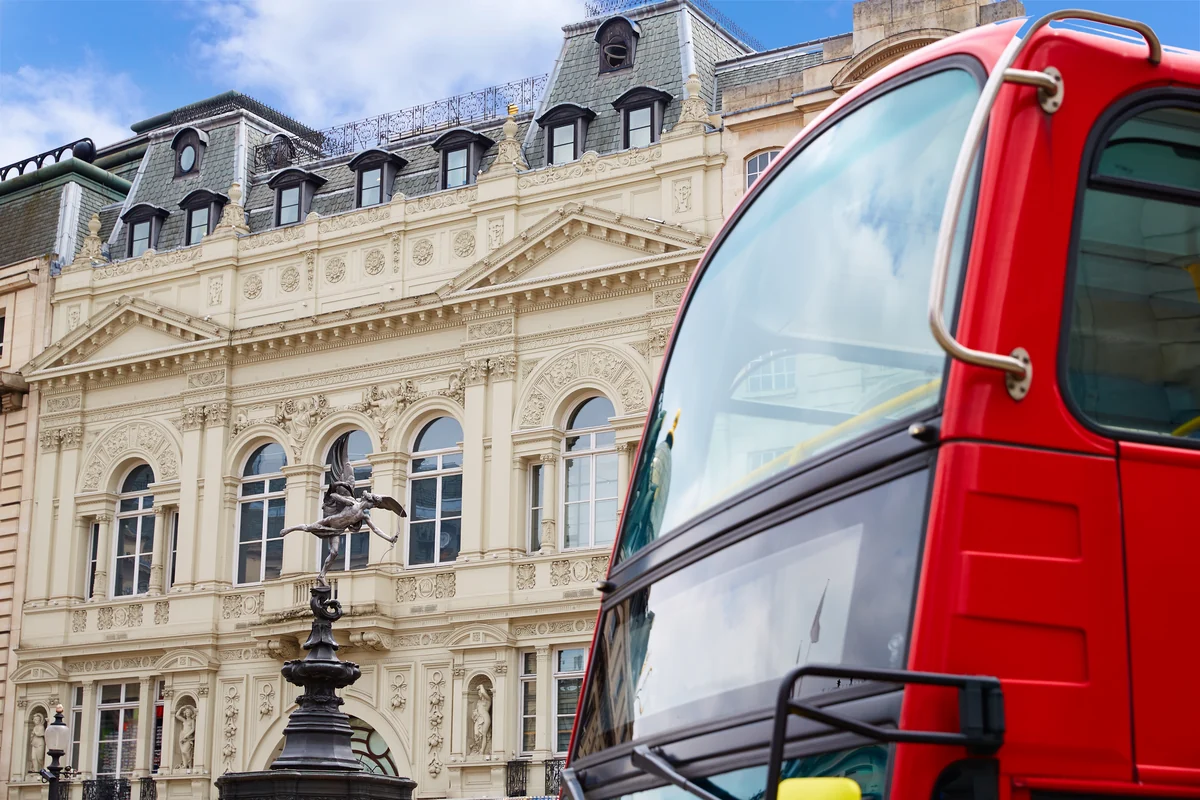 The Shaftesbury Memorial fountain at Piccadilly Circus with a red London bus passing by